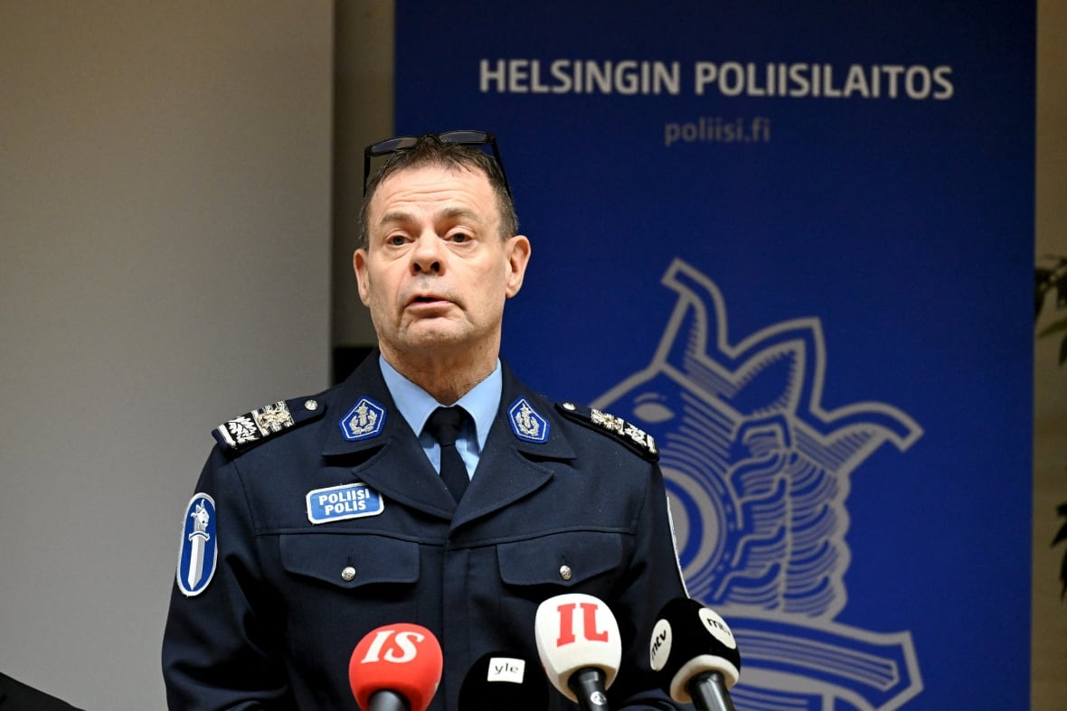 A police officer in uniform speaks at a news conference.